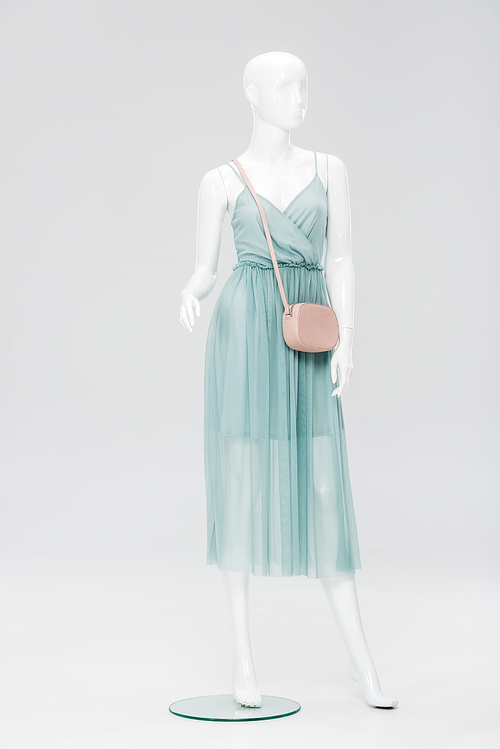 plastic mannequin with bag and dress isolated on grey