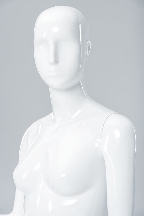 white plastic mannequin figure isolated on grey
