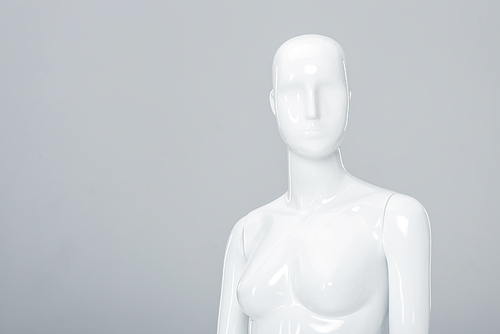 white plastic mannequin figure isolated on grey with copy space
