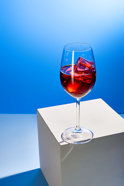 cocktail Aperol Spritz with ice cubes in glass on blue background