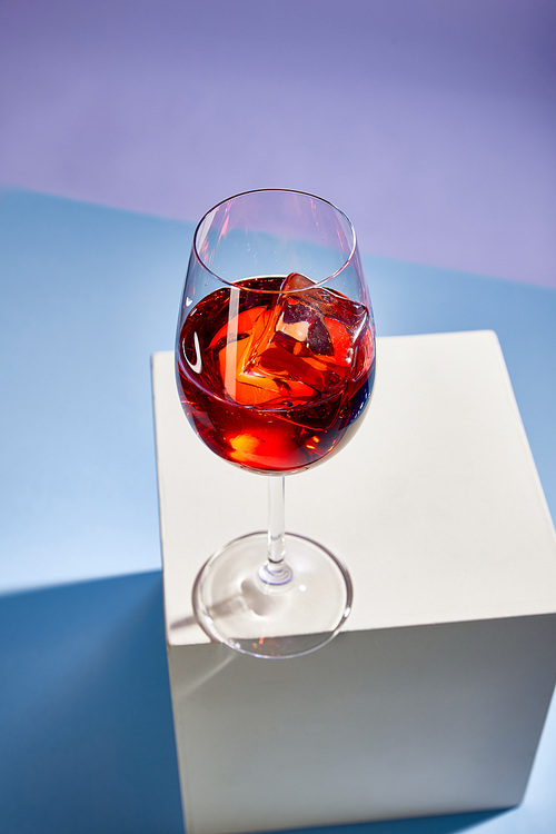 high angle view of cocktail Aperol Spritz in glass on blue background