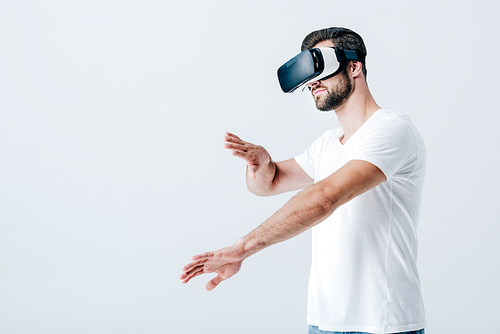 bearded man in Virtual reality headset gesturing isolated on grey
