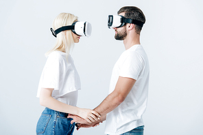 man and girl in Virtual reality headsets holding hands isolated on grey
