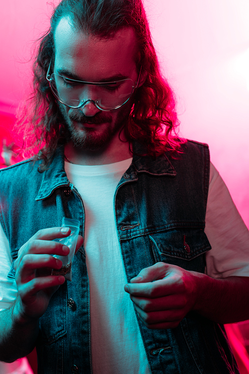 man holding plastic zipper bag with marijuana in nightclub