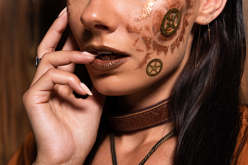 cropped view of woman with steampunk makeup on brown