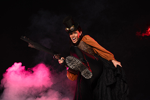 aggressive steampunk woman in top hat holding gun in pink smoke on black