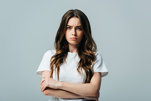 sad beautiful girl in white t-shirt with crossed arms  isolated on grey