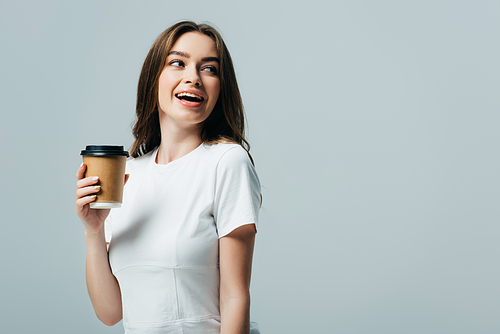 happy beautiful girl in white t-shirt with paper cup looking away isolated on grey