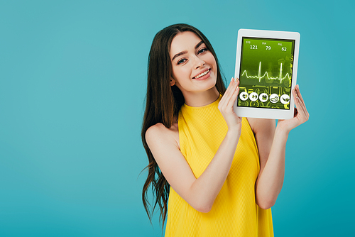 beautiful happy girl in yellow dress showing digital tablet with healthcare app isolated on turquoise