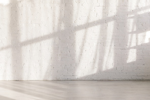 sunlight and shadows on brick wall in empty yoga studio