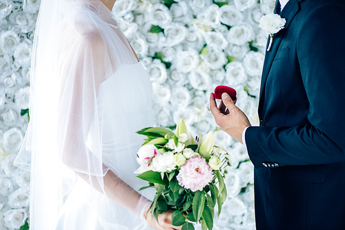 side view of bridegroom making proposal to bride in wedding dress