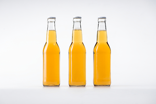 bottles of beer in row on white background