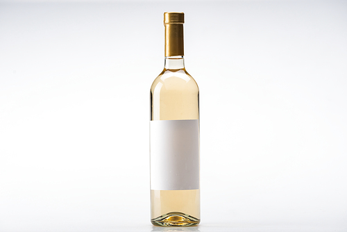 bottle of white wine with blank label on white background