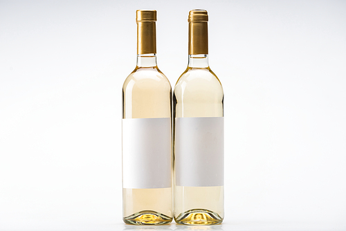 bottles of white wine with blank labels on white background