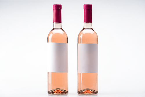 bottles of rose wine with blank labels on white background