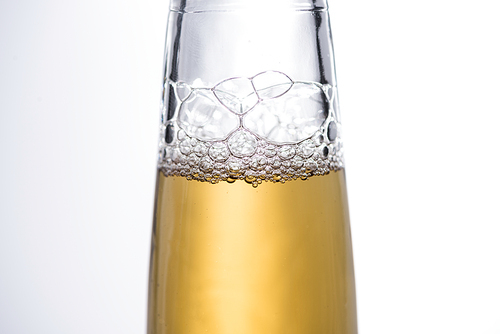 close up view of beer bottle with bubbles isolated on white