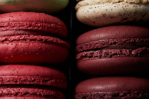 close up view of assorted delicious colorful french macaroons