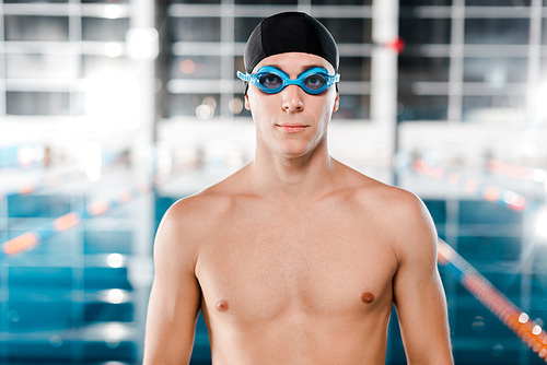 handsome swimmer in goggles and swimming cap 