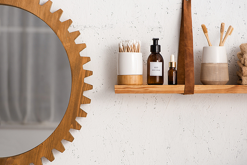 Shelf with beauty and cosmetic products with mirror in bathroom, zero waste concept