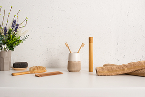 Flowerpot, towels and hygiene objects in bathroom, zero waste concept