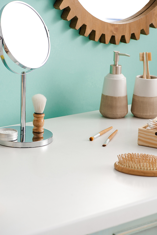 Various beauty and hygiene objects with round mirrors in bathroom, zero waste concept