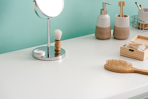 Various beauty and hygiene objects with round mirror in bathroom, zero waste concept