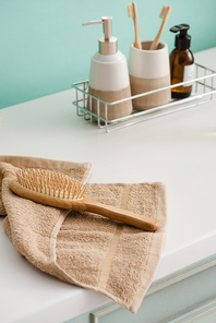 Hygiene products on shelf with hairbrush on towel in bathroom, zero waste concept