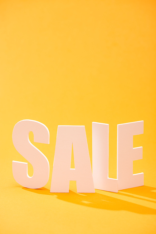 white sale lettering on bright orange background