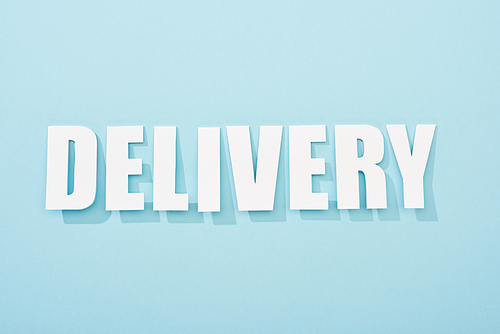 white delivery text with shadow on blue background with copy space