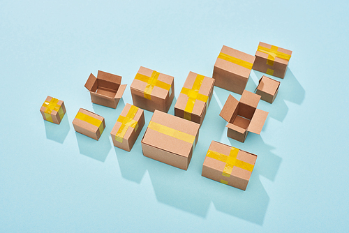 top view of cardboard boxes on blue background with copy space