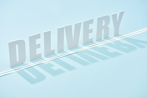 white delivery inscription with shadow and double line on blue background with copy space