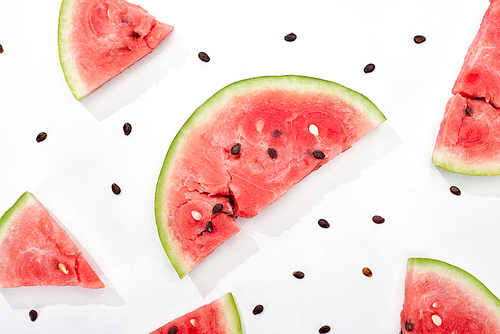 top view of delicious juicy watermelon slices with seeds on white background