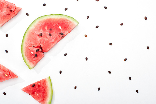 top view of delicious juicy cut watermelon with seeds on white background