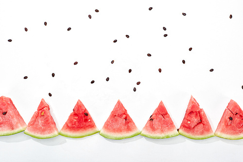 flat lay with delicious juicy watermelon slices and scattered seeds on white background