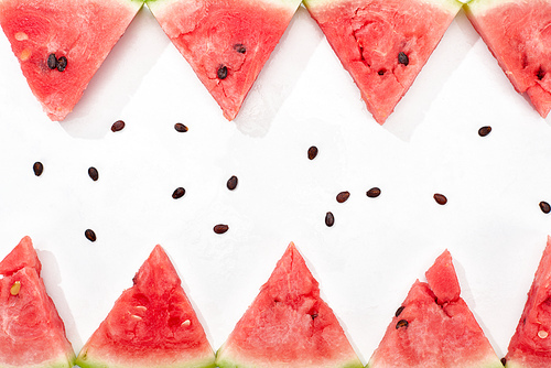 flat lay with delicious juicy watermelon slices and seeds on white background