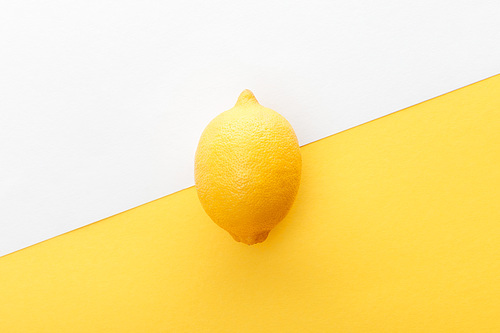 Top view of lemon on yellow and white background