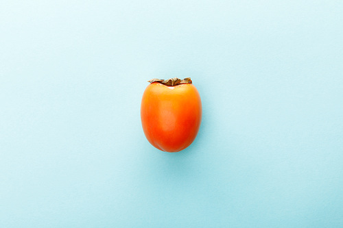 Top view of persimmon on blue background