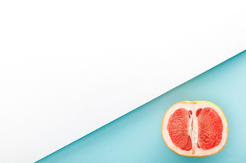 Top view of grapefruit half on blue and white background