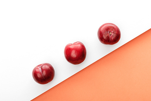 Top view of apples on white and orange background