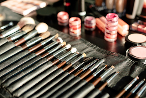 selective focus of makeup brush set near lip balms