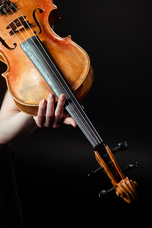 cropped view of female musician playing symphony on violin isolated on black