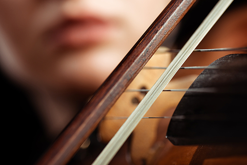 cropped view of female musician playing on violin, selective focus