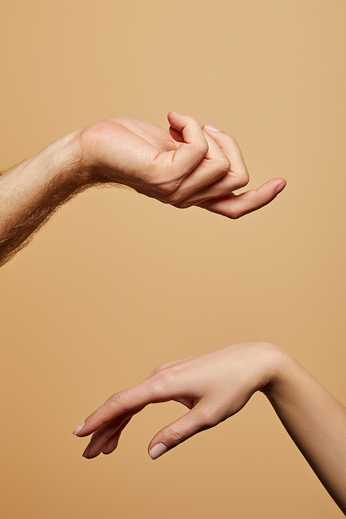 cropped view of man and woman gesturing isolated on beige