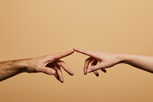 cropped view of man and woman touching with fingers isolated on beige