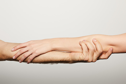 cropped view of man and woman holding hands isolated on white