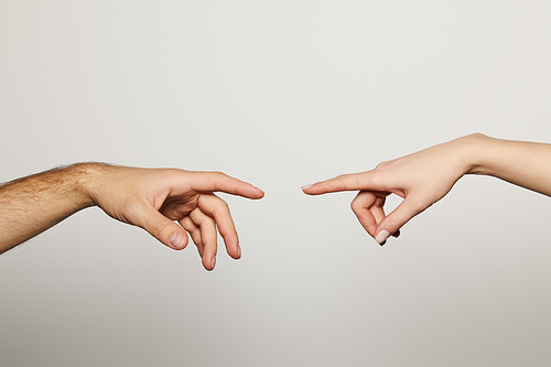 cropped view of man and woman reaching for each other isolated on white