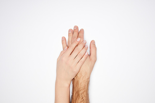 top view of couple holding hands isolated on white