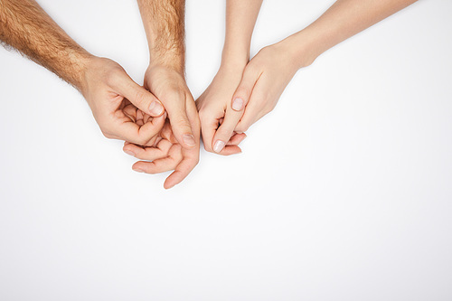 top view of male and female hands isolated on white