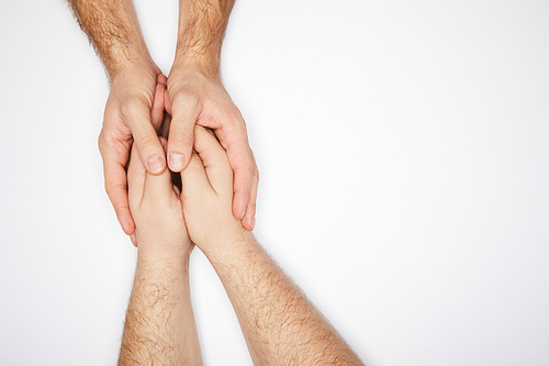 top view of two men holding hands isolated on white