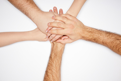 top view of men and women holding hands isolated on white